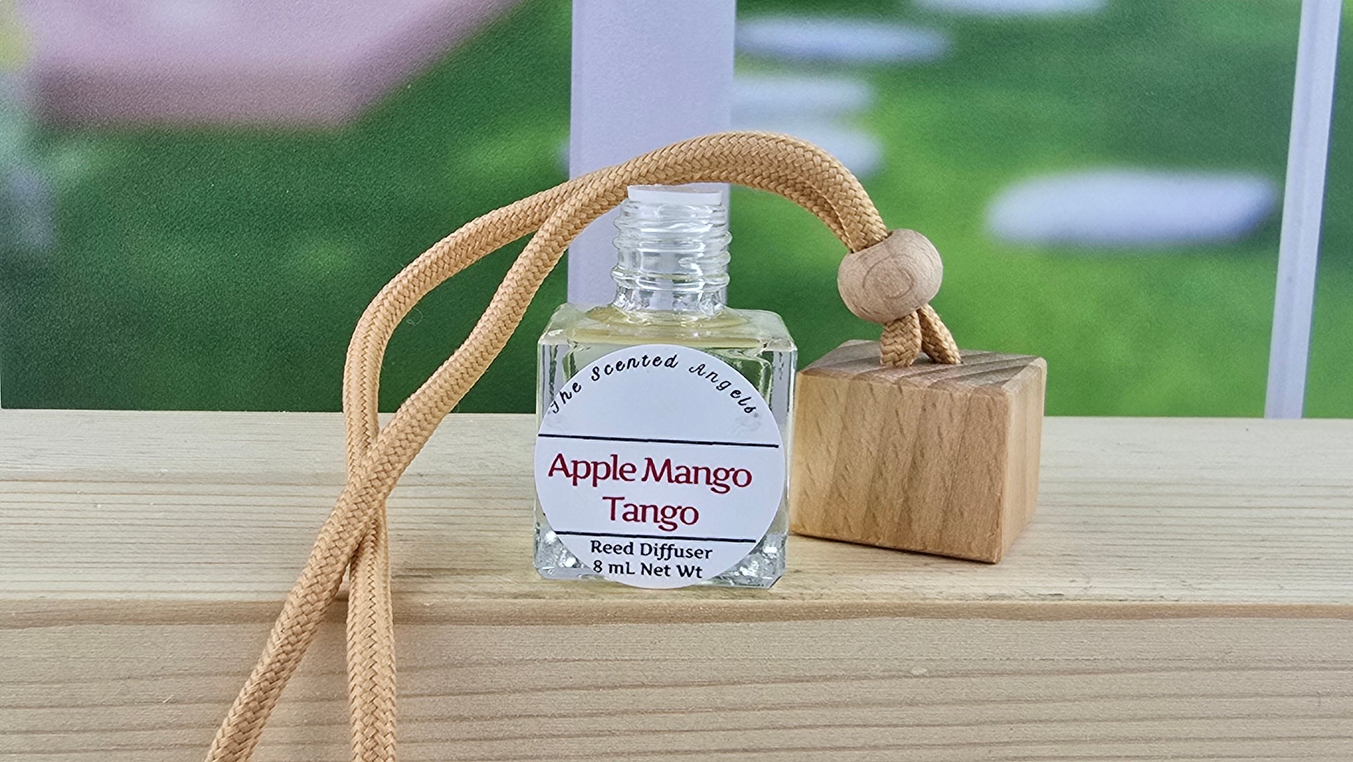Apple Mango Tango handmade hanging car diffuser by The Scented Angels featuring a fresh laundry-inspired fragrance with peach, pineapple, apple, orange blossom, jasmine, rose, and soft floral notes.