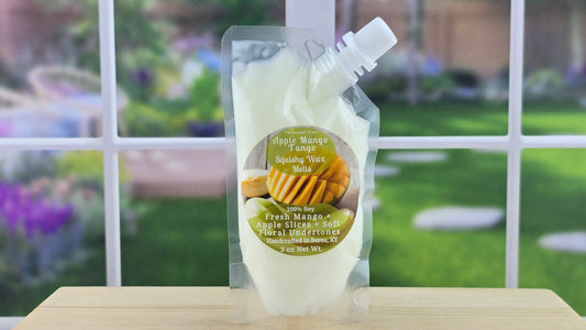 A pouch of Apple Mango Tango Squeezy Wax Melts with a white background, featuring images of apples and mangoes and text describing the product.