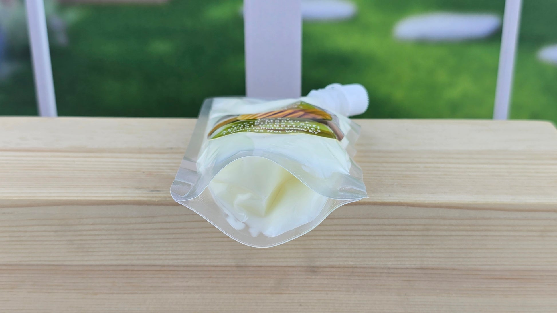 squeezable wax melt laying on wooden surface