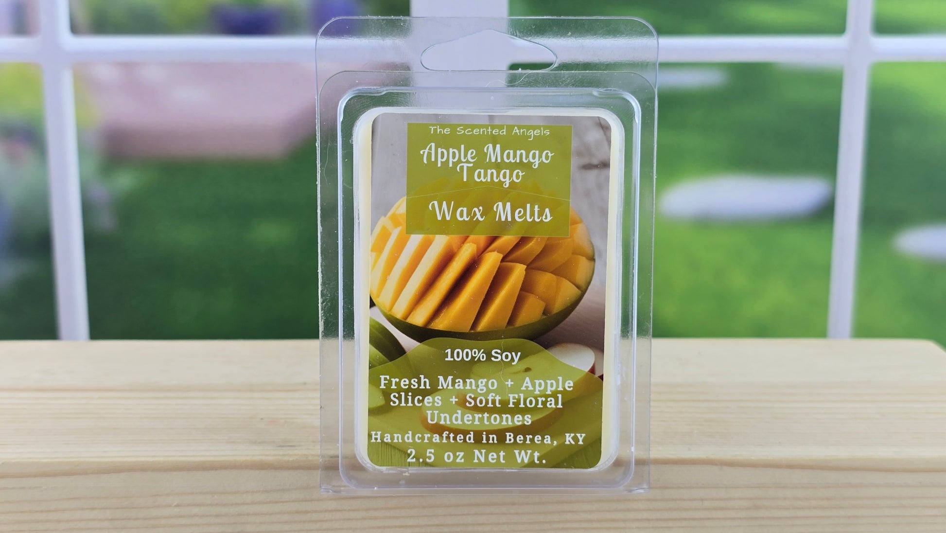 Packaged wax melts with apple and mango flavor on a wooden surface