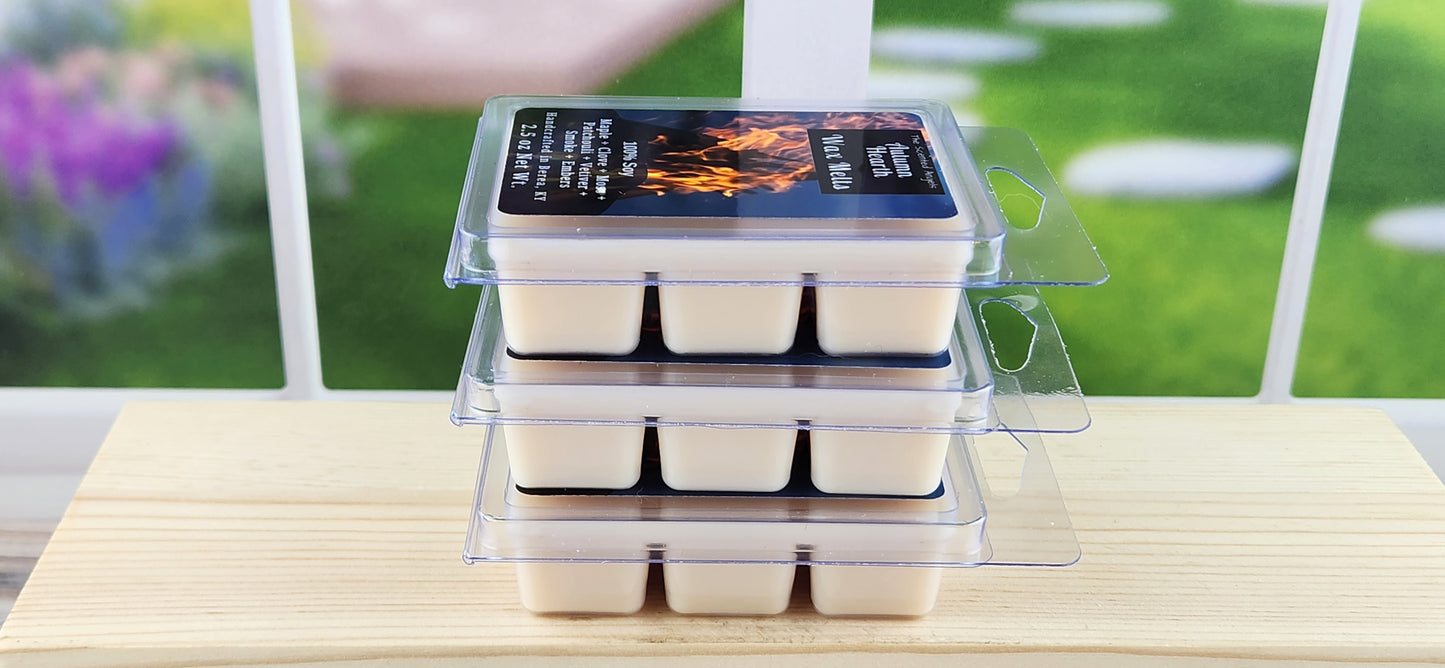 Stack of wax melts in clear packaging on a wooden surface with a blurred outdoor background