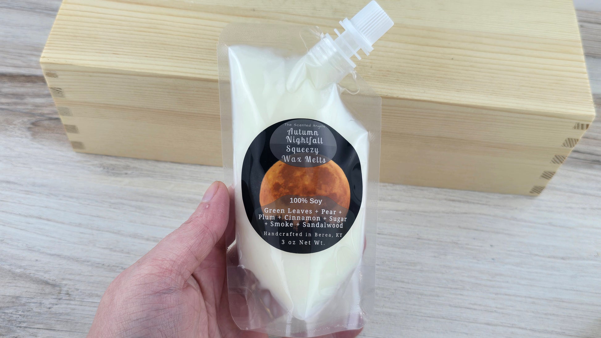 Autumn Nightfall Squeezy Wax Melts holding it in hand to show size of pouch