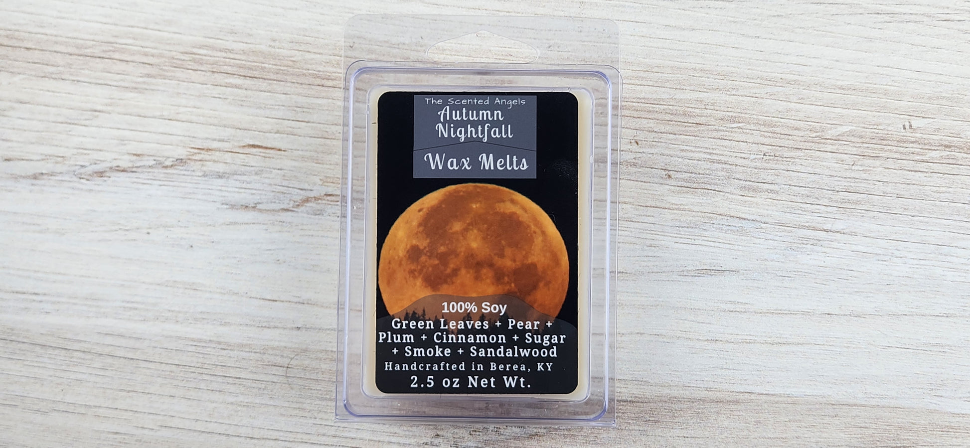 Wax melt packaging with moon design on a wooden surface