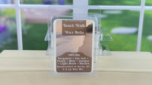 Beach Walk wax melt packaging on a wooden surface with a blurred outdoor background