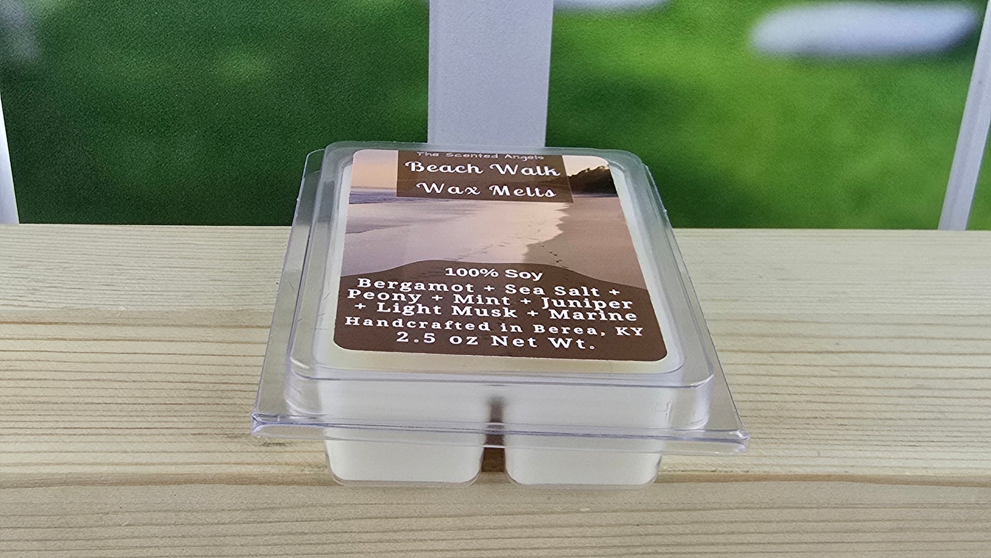 Beach Walk wax melts packaging on a wooden surface with a blurred green background