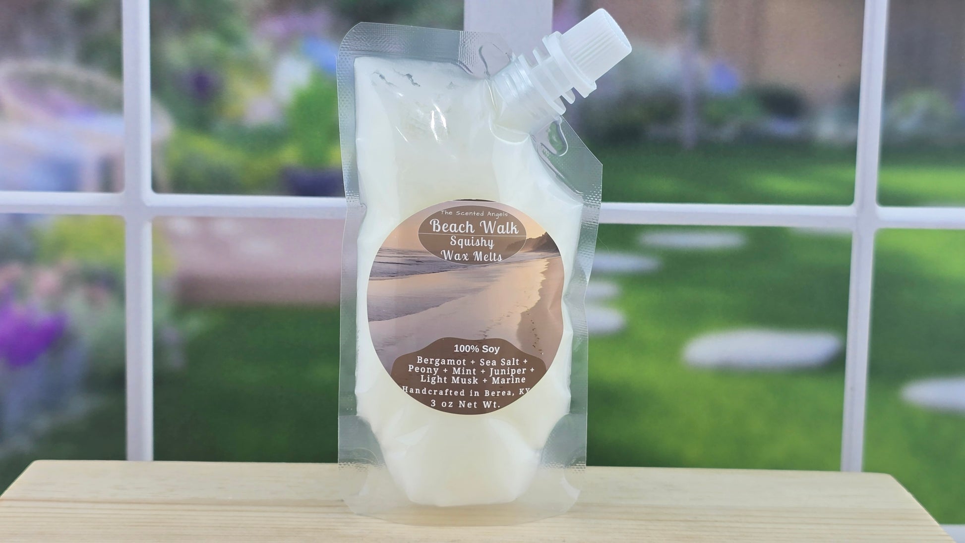 squeezable wax melt pouch 3 oz on wooden surface with blurred garden background