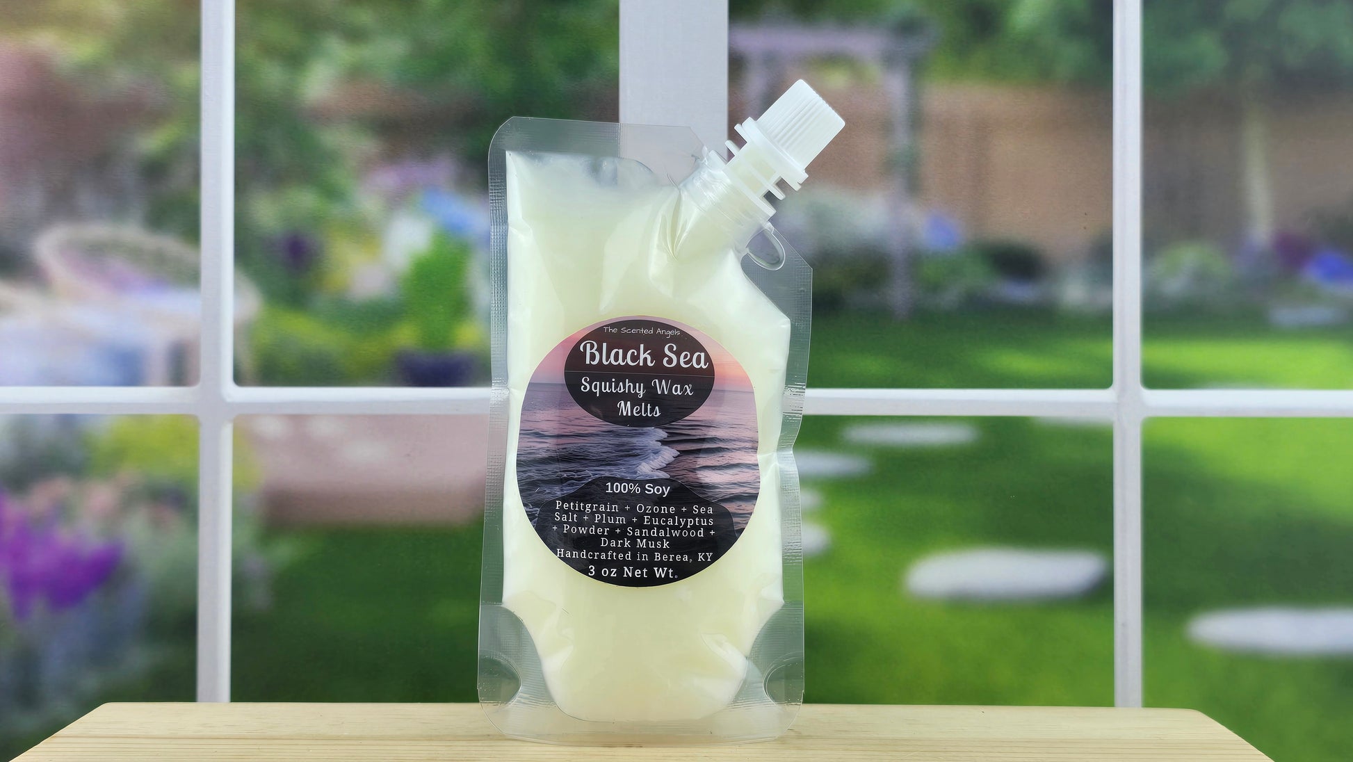 Packaged product labeled 'Black Sea' on a wooden surface with a blurred outdoor background