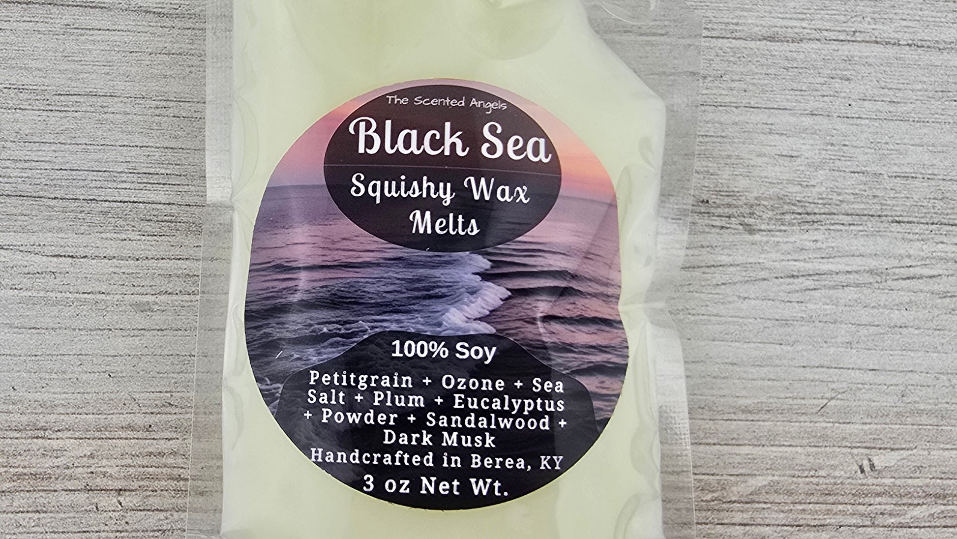 Packaging of Black Sea Squishy Wax Melts with label on a textured gray background