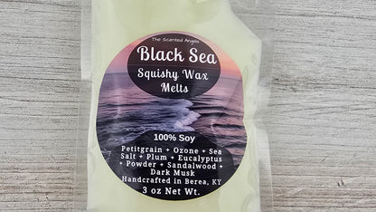 Packaging of Black Sea Squishy Wax Melts with label on a textured gray background