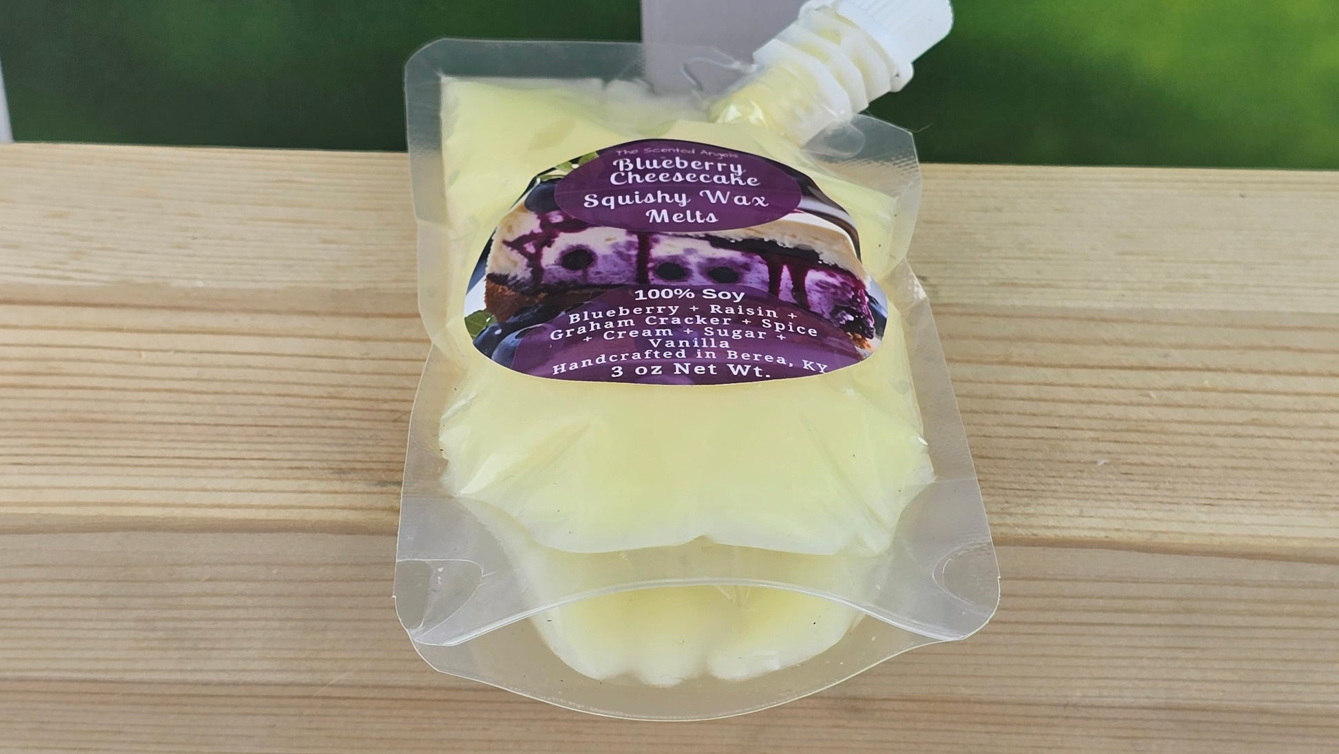squeezy wax melt packaging on wooden surface