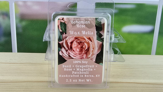 Bohemian Rose wax melt packaging on a wooden surface with a blurred outdoor background