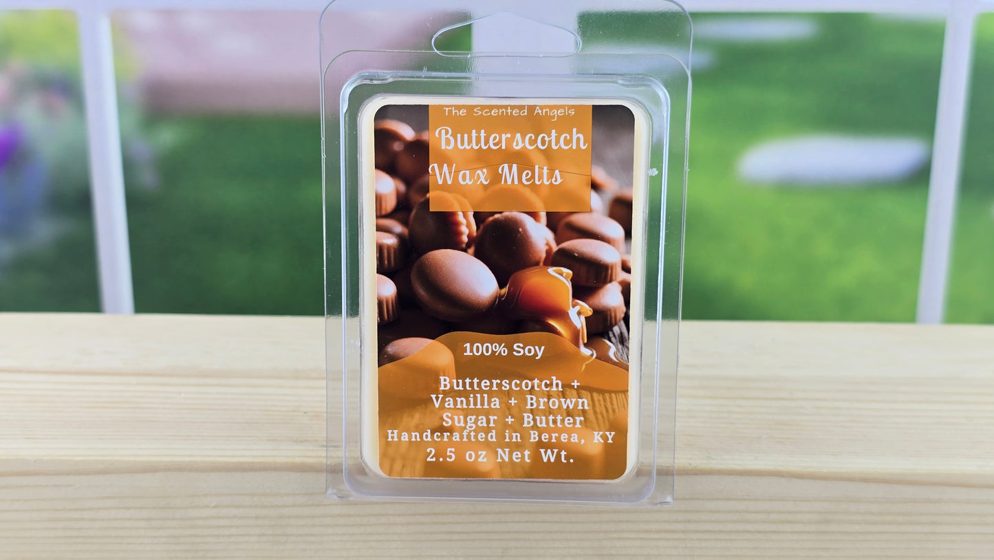 Butterscotch wax melts packaging on a wooden surface with a blurred outdoor background