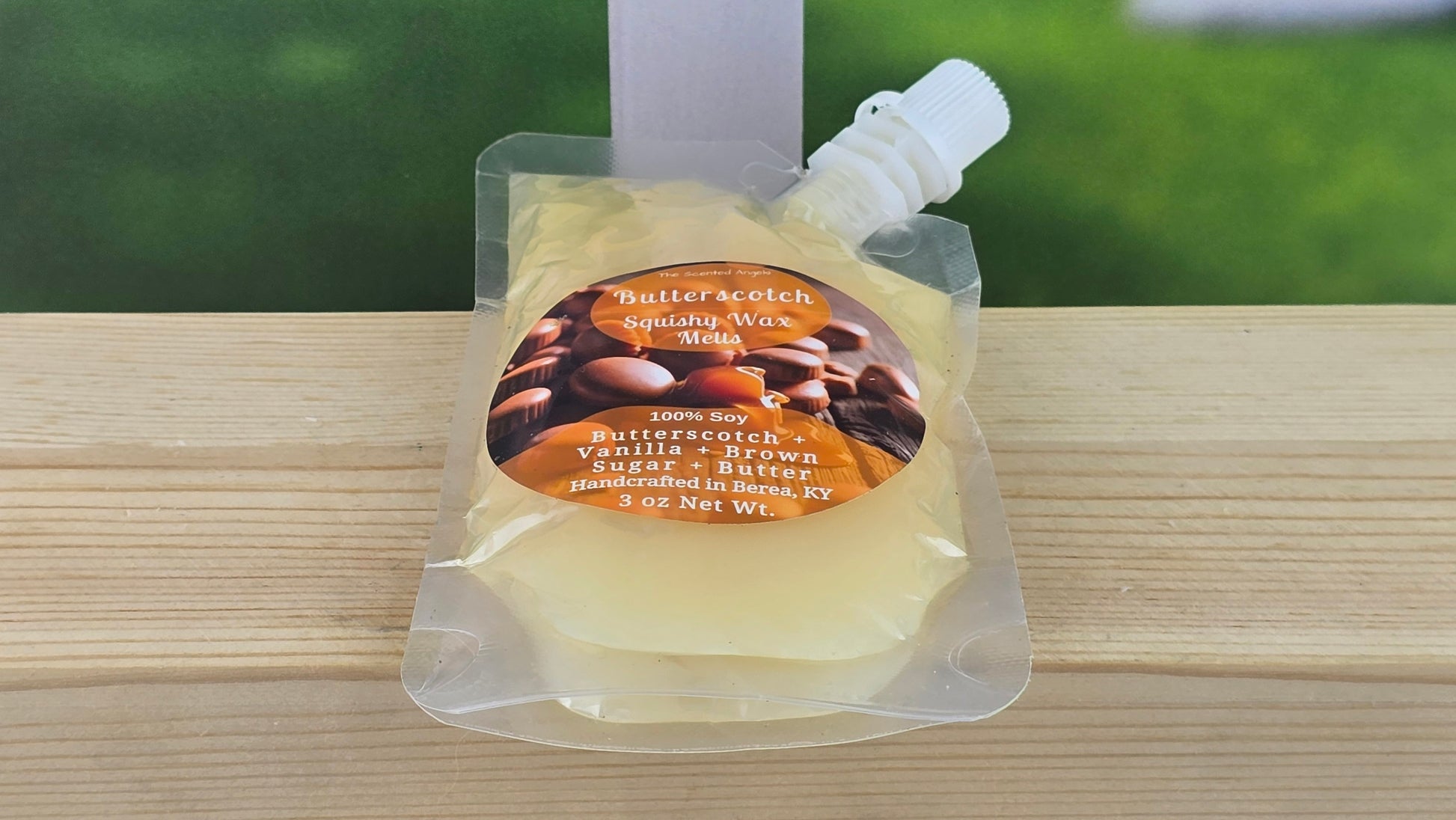 squeezable wax melt pouch laying flat on a wooden surface