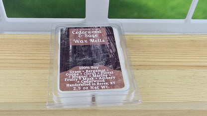 Cedarwood & Sage wax melt packaging on a wooden surface with a window in the background