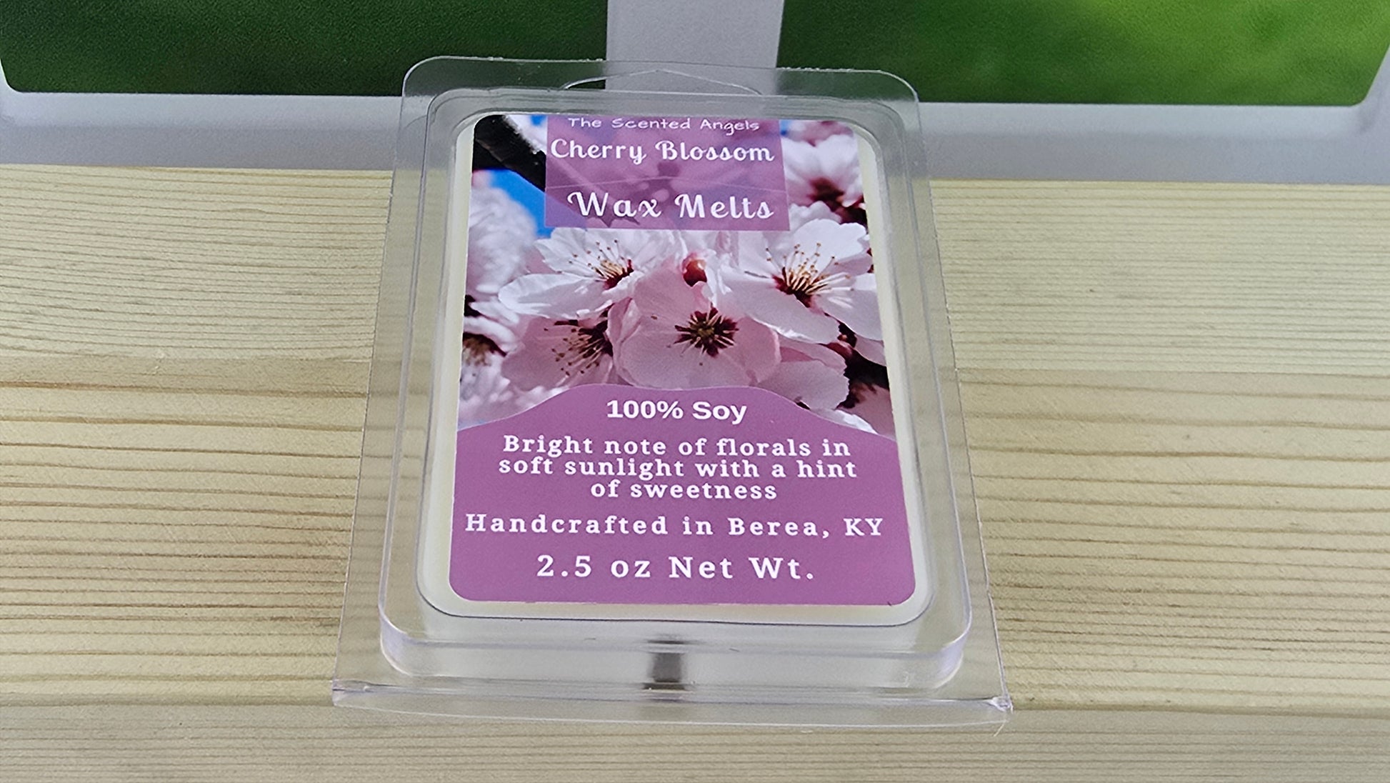 Cherry blossom wax melts packaging on a wooden surface