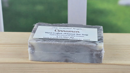 Bar of soap with a label on a wooden surface