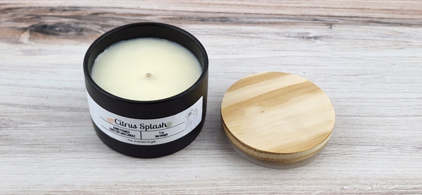 Candle in a black container with a wooden lid on a wooden surface
