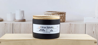 Candle labeled 'Citrus Splash' with a wooden lid on a wooden surface.