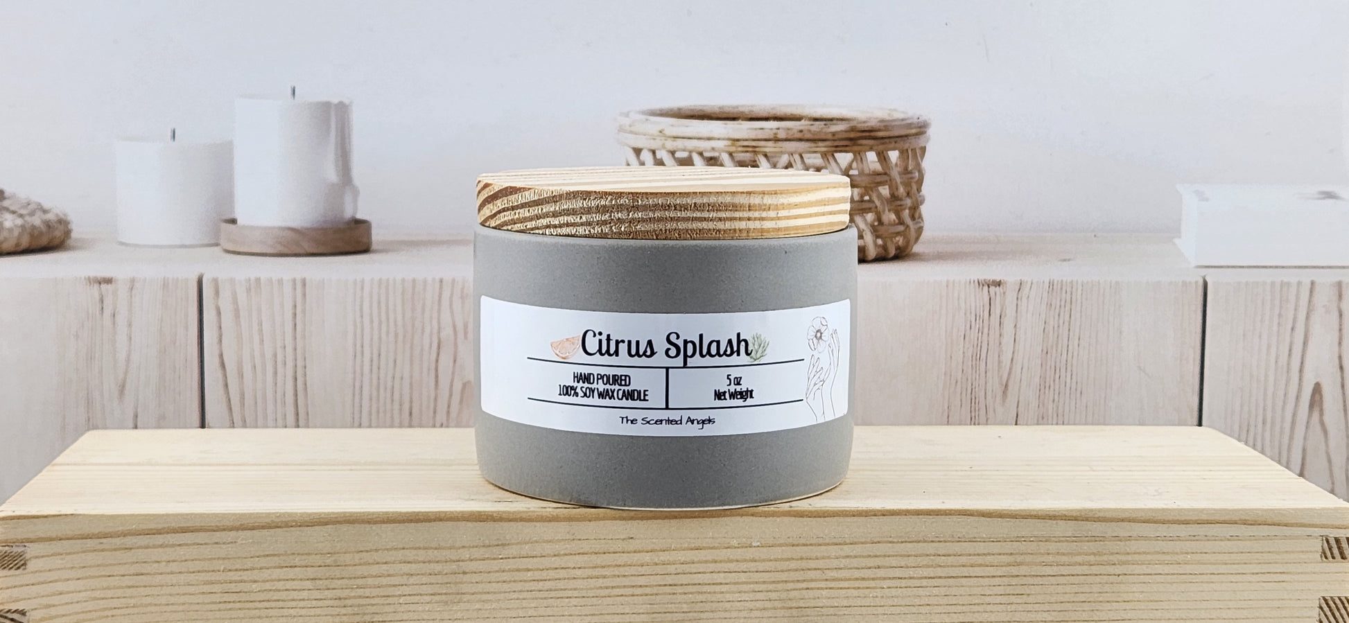 Candle labeled 'Citrus Splash' on a wooden surface with a neutral background