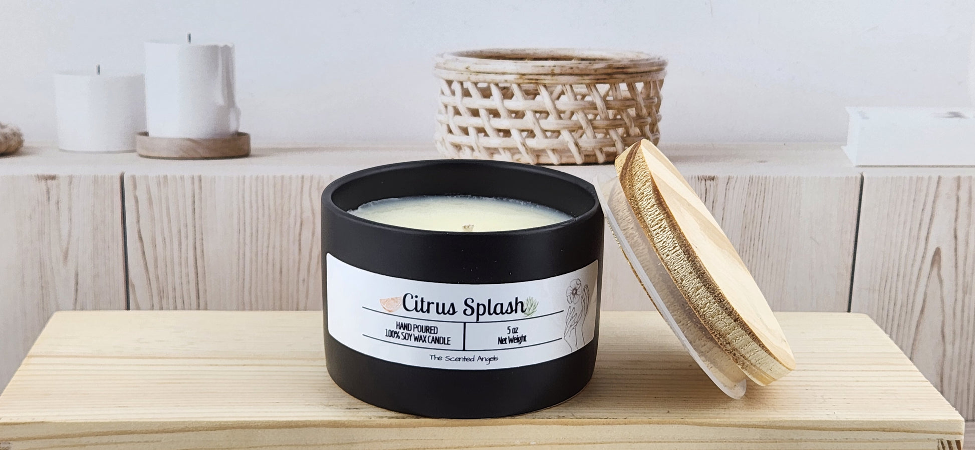 Candle labeled 'Citrus Splash' on a wooden surface with a wicker basket in the background.