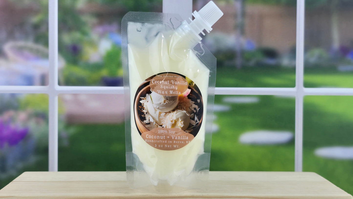 A pouch of handmade coconut vanilla 100% soy squeezy wax melts placed on a wooden stand with a view of a garden through the window.