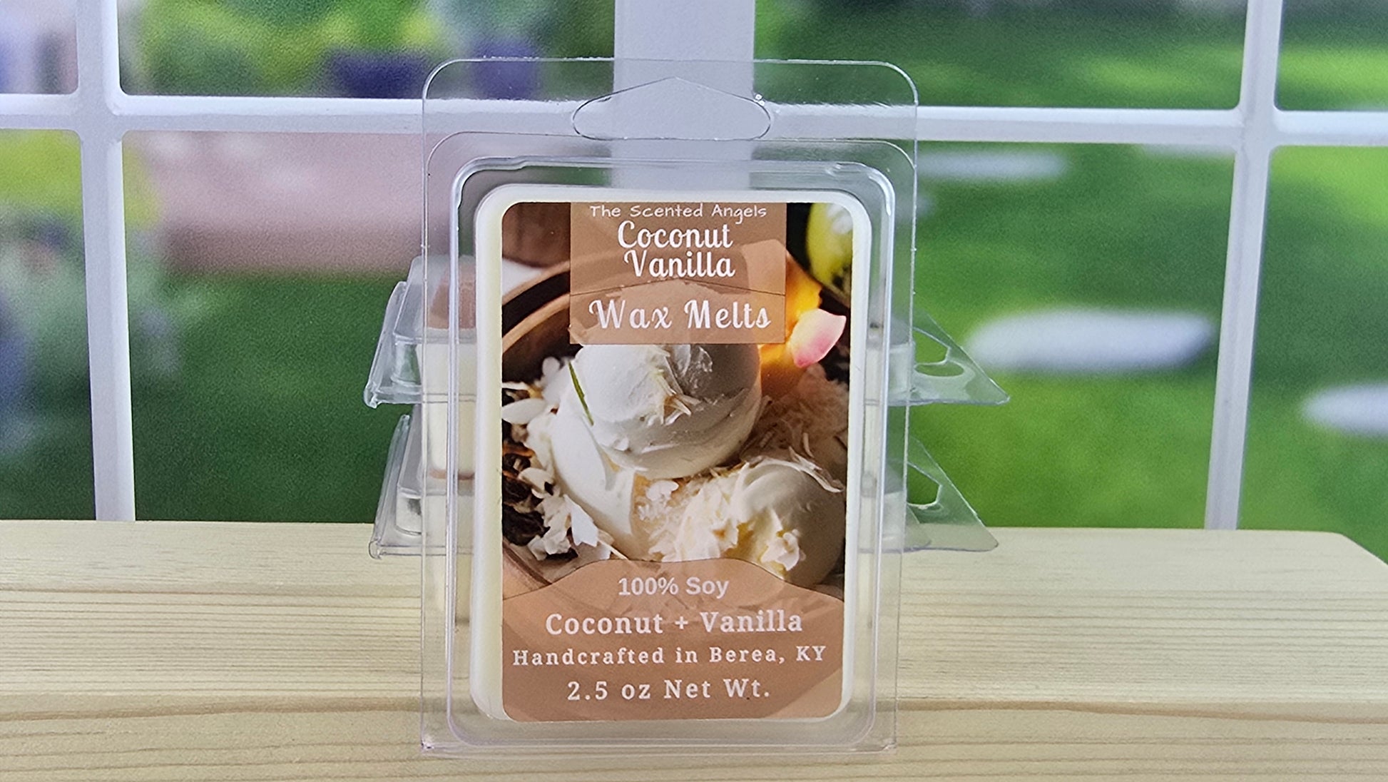 Coconut Vanilla wax melts packaging on a wooden surface with a blurred outdoor background