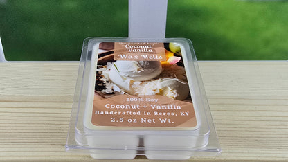 Pack of coconut vanilla wax melts on a wooden surface with a blurred green background