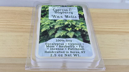 Packaged wax melts with Cypress & Bayberry fragrance on a wooden surface