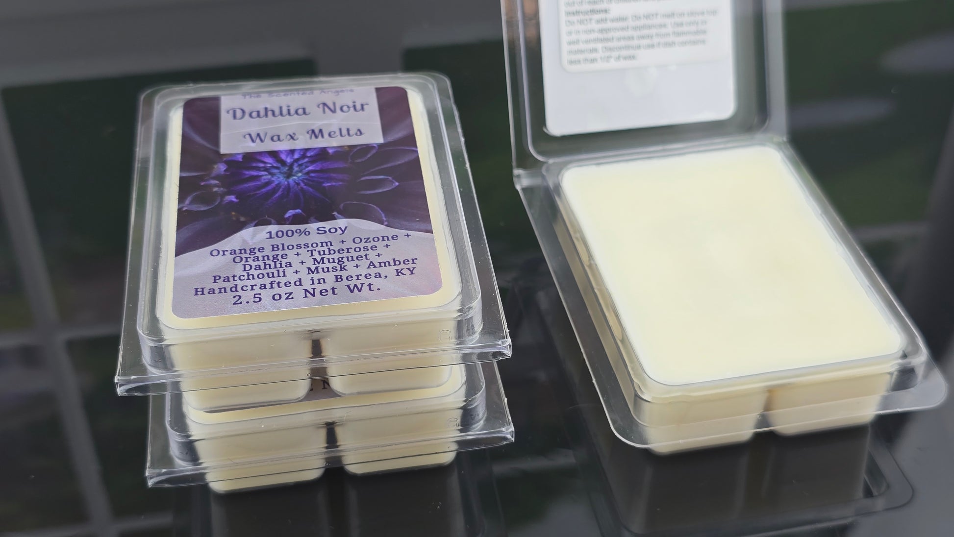 Wax melts in clear packaging with labels on a dark surface