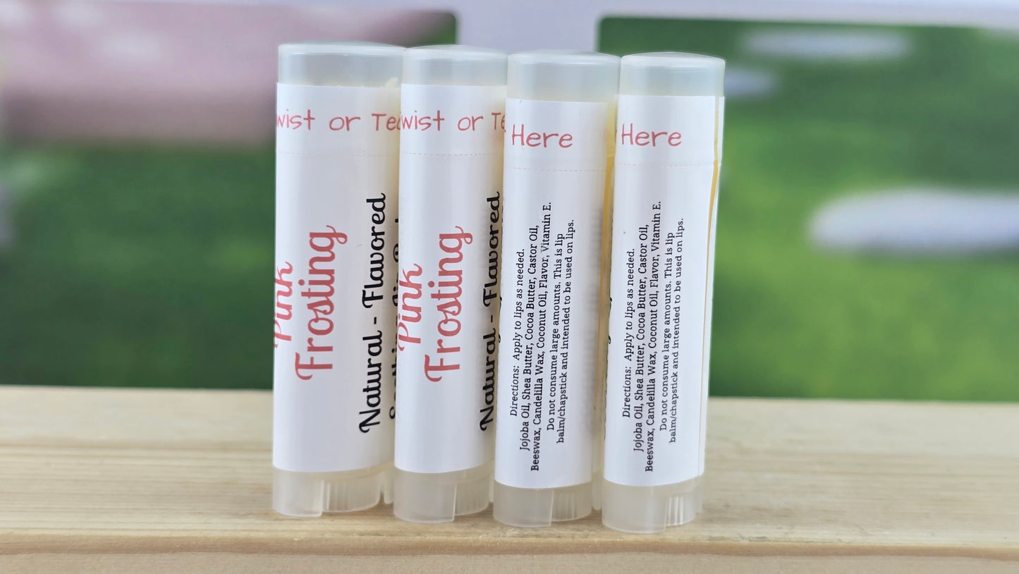 Four lip balm tubes with text on a wooden surface