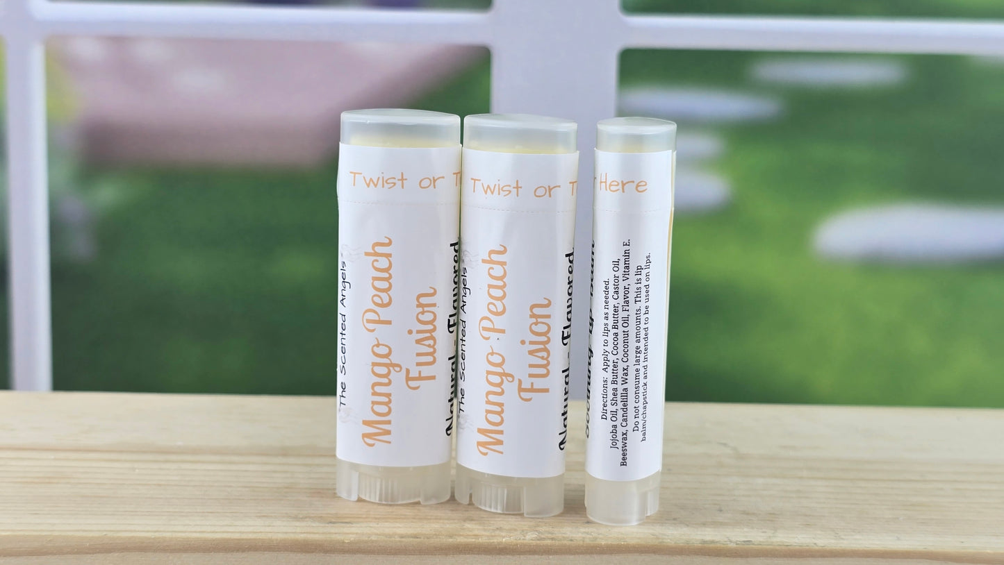 Three lip balm sticks with a blurred outdoor background