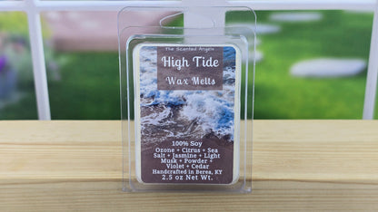 Wax melt package labeled 'High Tide' on a wooden surface with a blurred outdoor background.