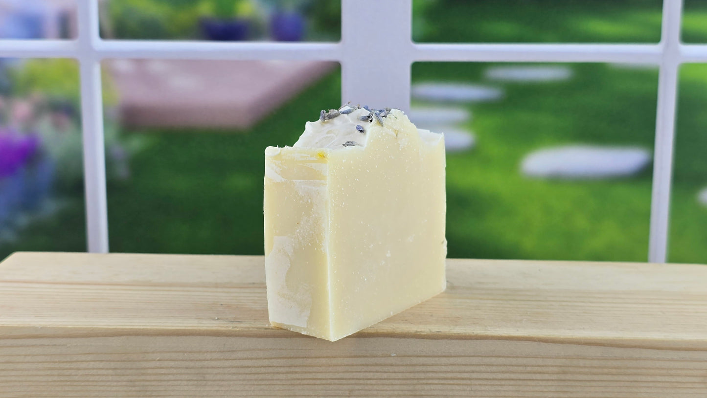 side view of lavender cold process soap on a wooden surface