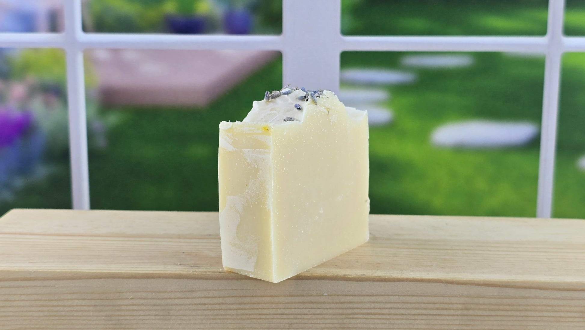 side view of lavender cold process soap on a wooden surface