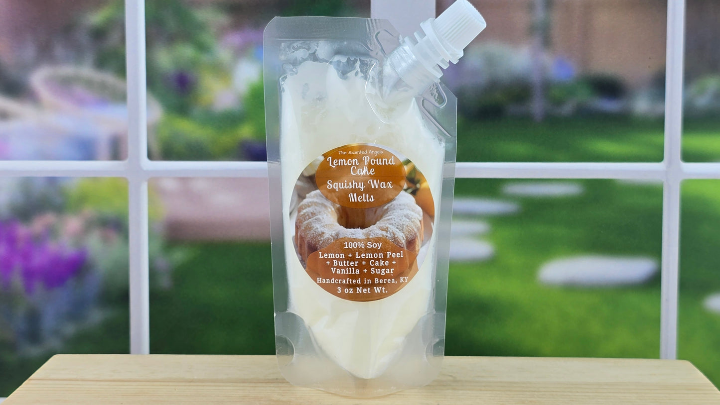 Packaged lemon pound cake scented wax melt on a wooden surface with a garden background