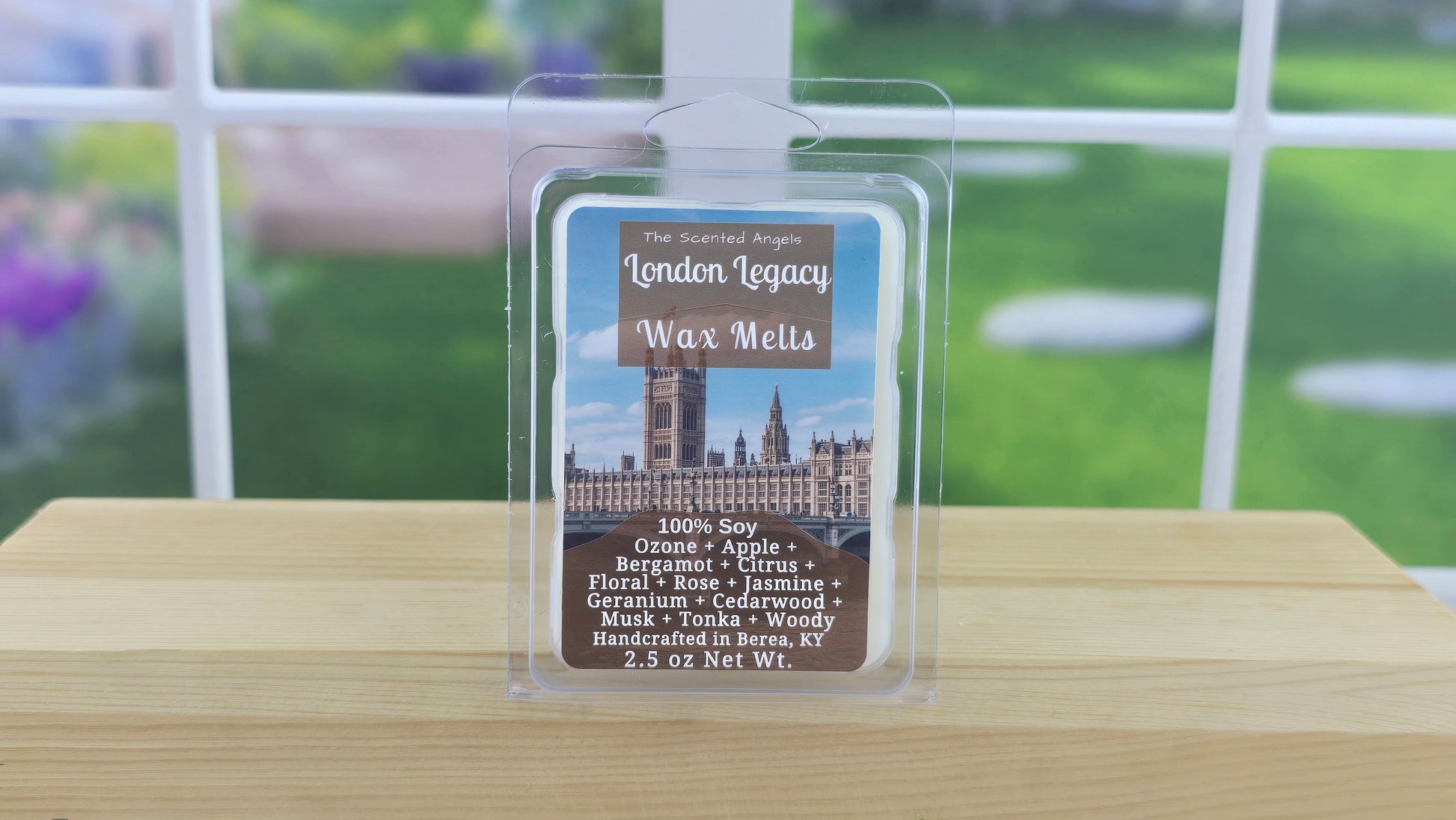 Packaged wax melts with a label on a wooden surface, blurred outdoor background