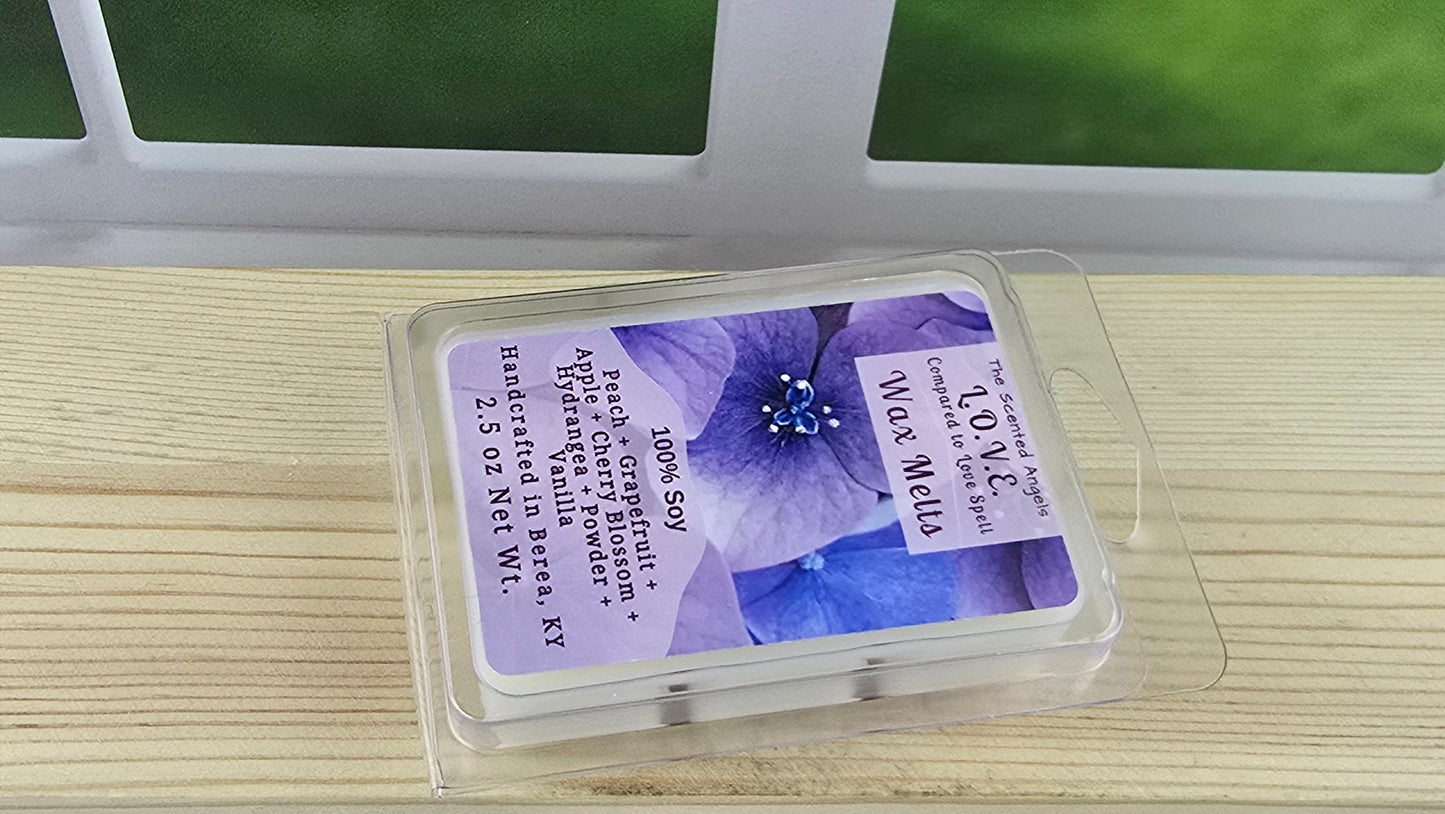 Wax melt packaging with purple label featuring a floral design on a wooden surface.