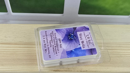 Wax melt packaging with purple label featuring a floral design on a wooden surface.