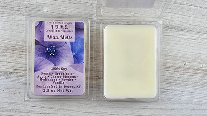 Wax melt packaging with a purple label on a gray surface