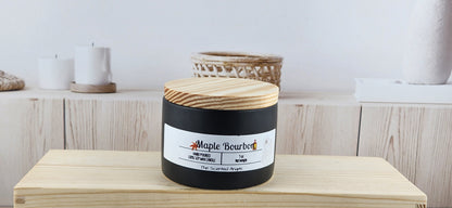 Candle with a wooden lid on a wooden surface, with a white background