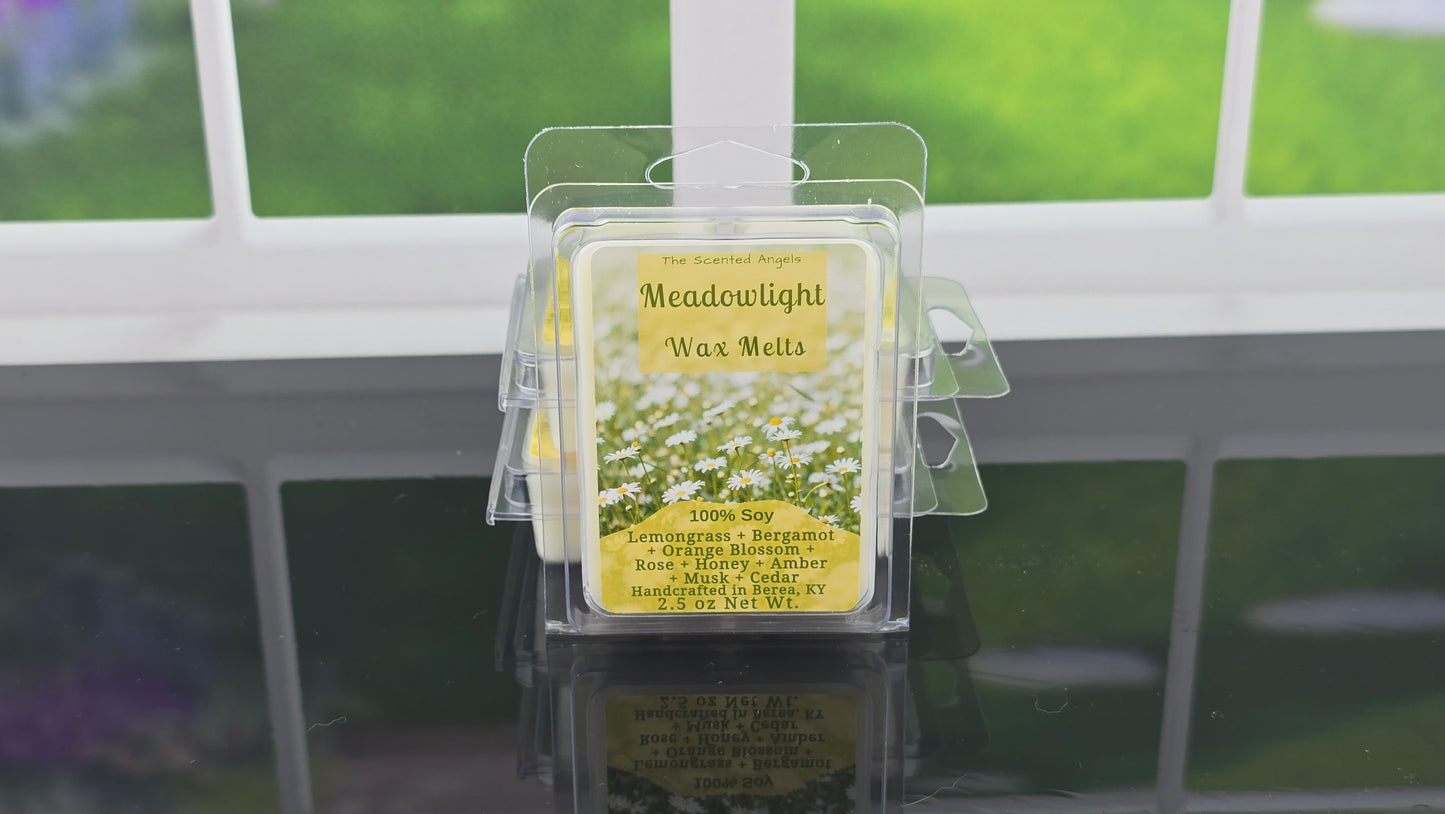 Meadowlight wax melts packaging on a clear stand with a window background