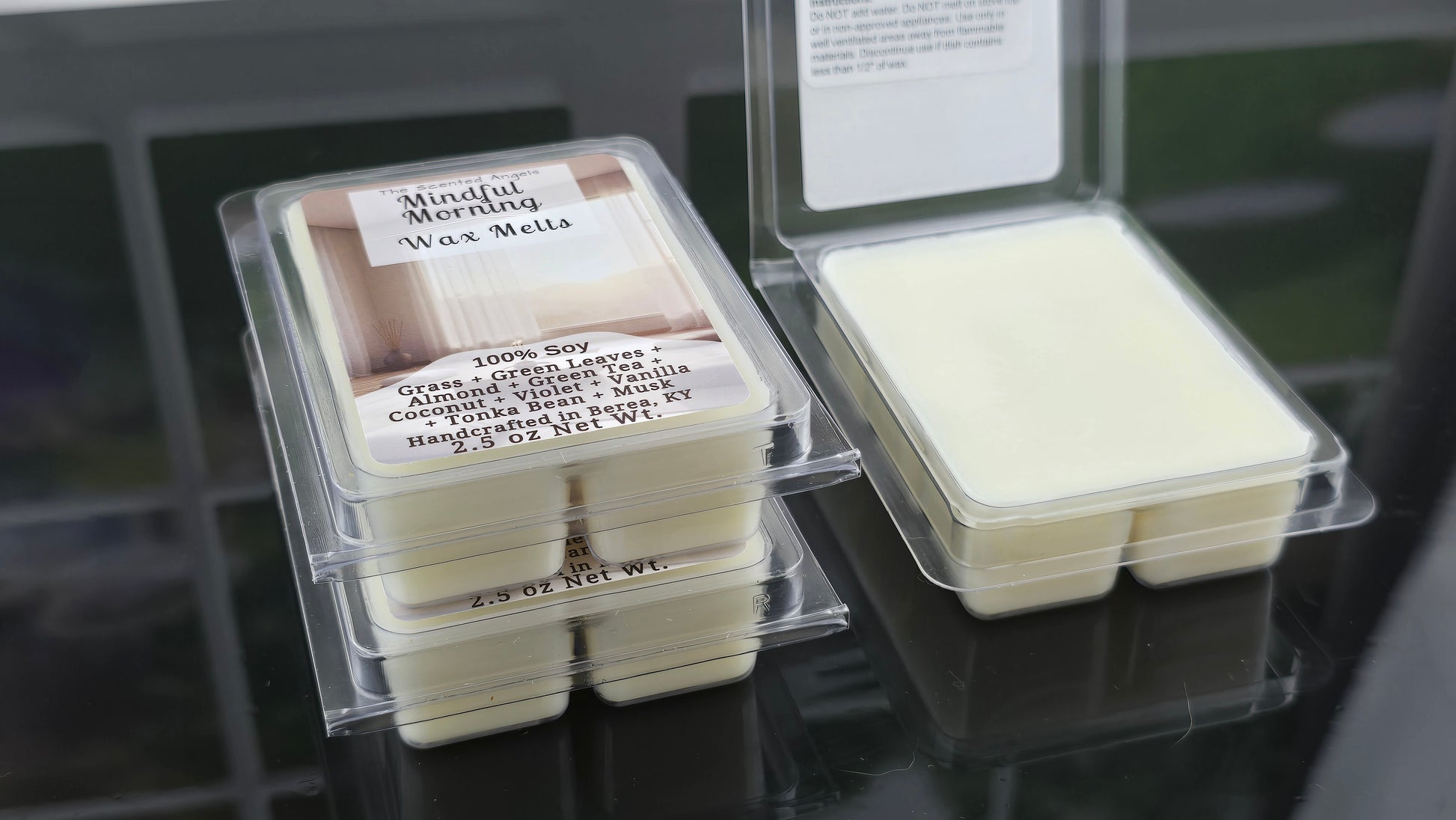 Wax melts in clear packaging with labels on a dark surface