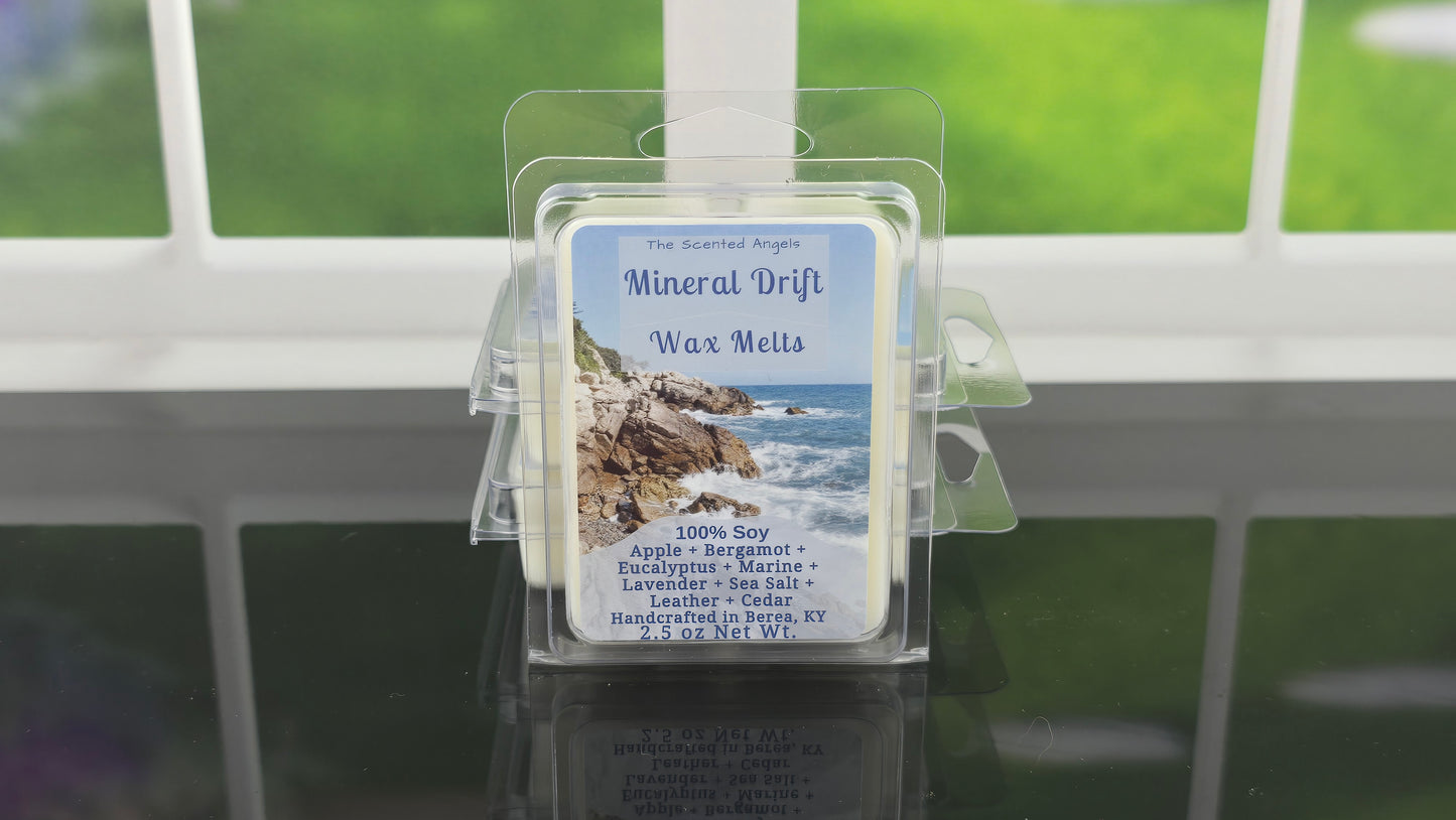 Wax melts packaging labeled 'Mineral Drift' on a reflective surface with a window background.