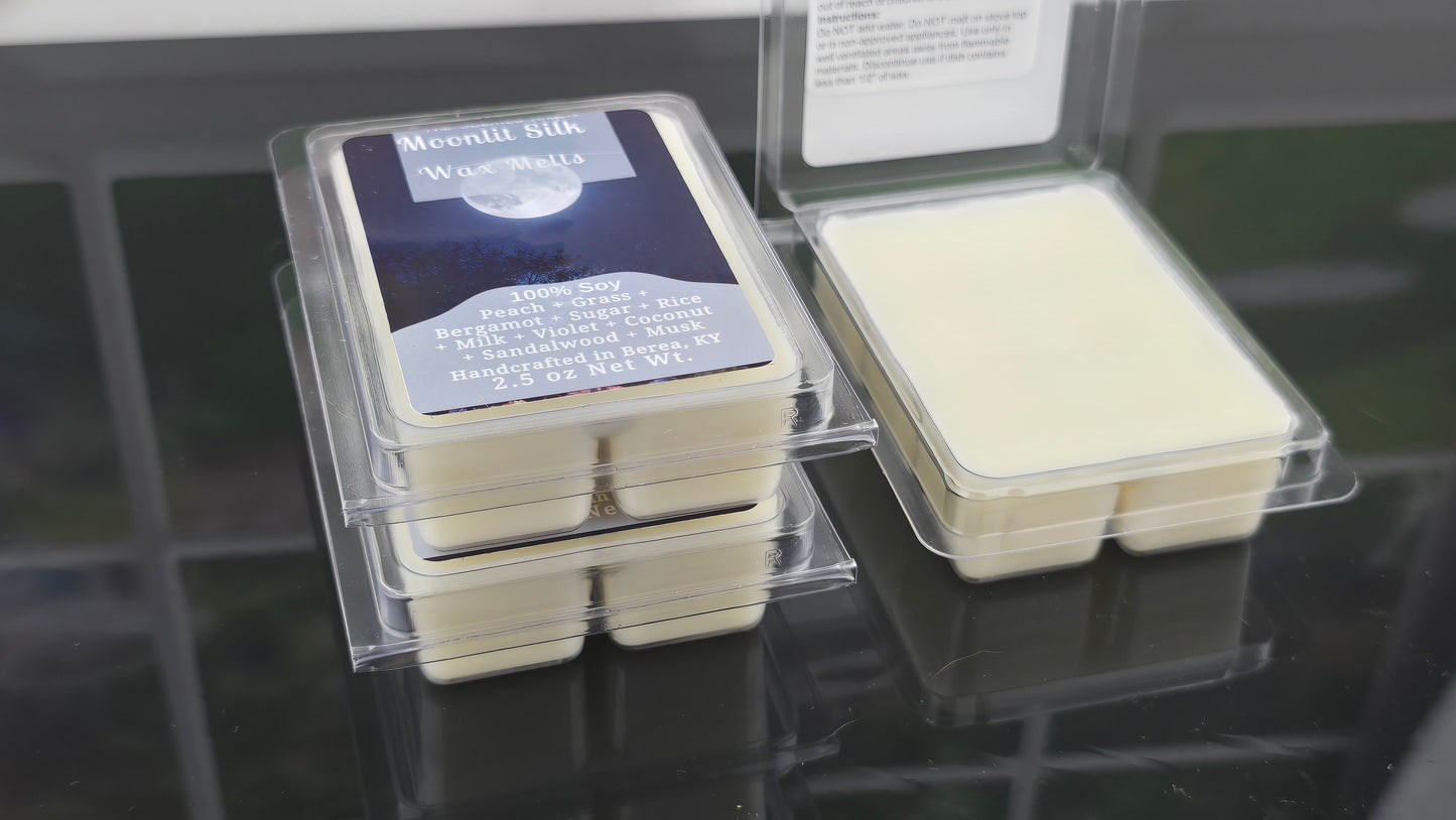 Packaged wax melts with labels on a reflective surface