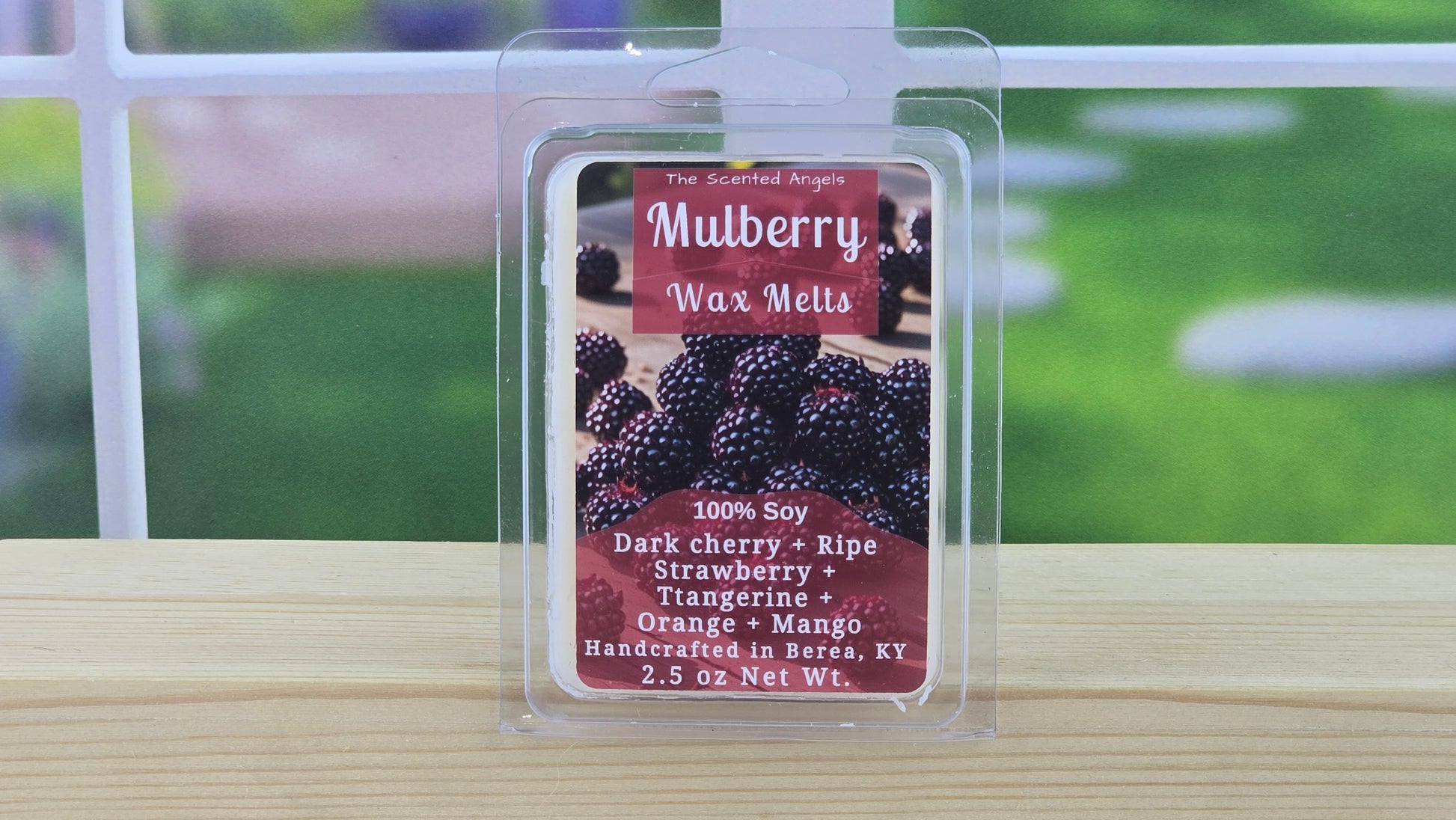 Mulberry wax melt package with a blurred outdoor background