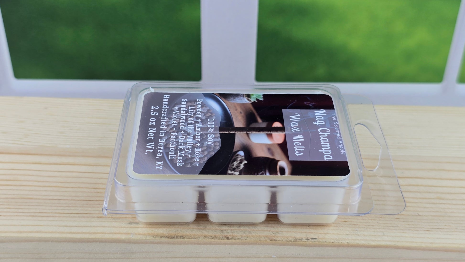 Packaged wax melts on a wooden surface with a window in the background