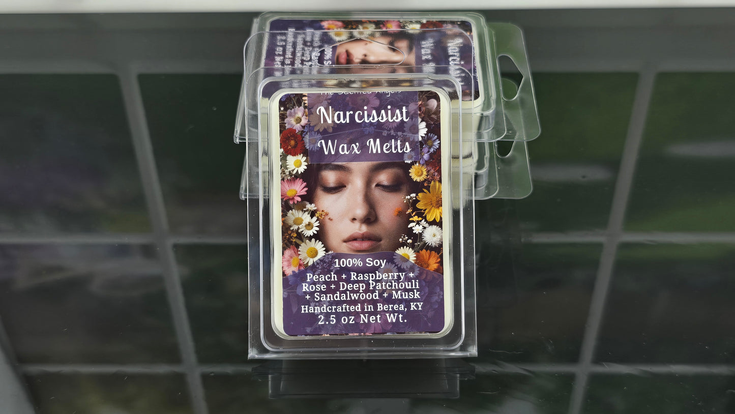 Stack of wax melt packages with decorative labels on a tiled surface