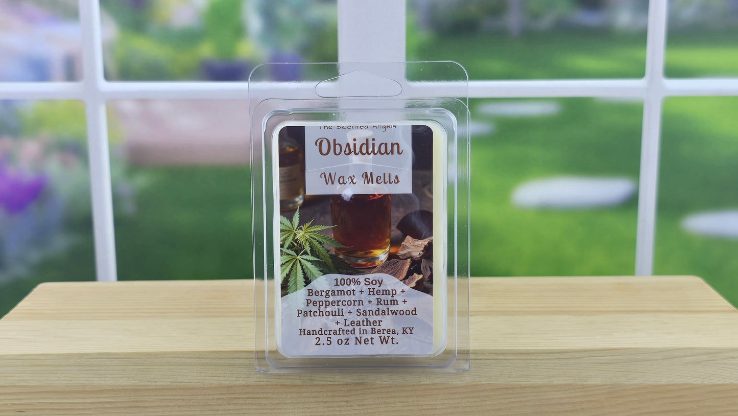 Obsidian Wax Melts packaging on a wooden surface with a blurred outdoor background