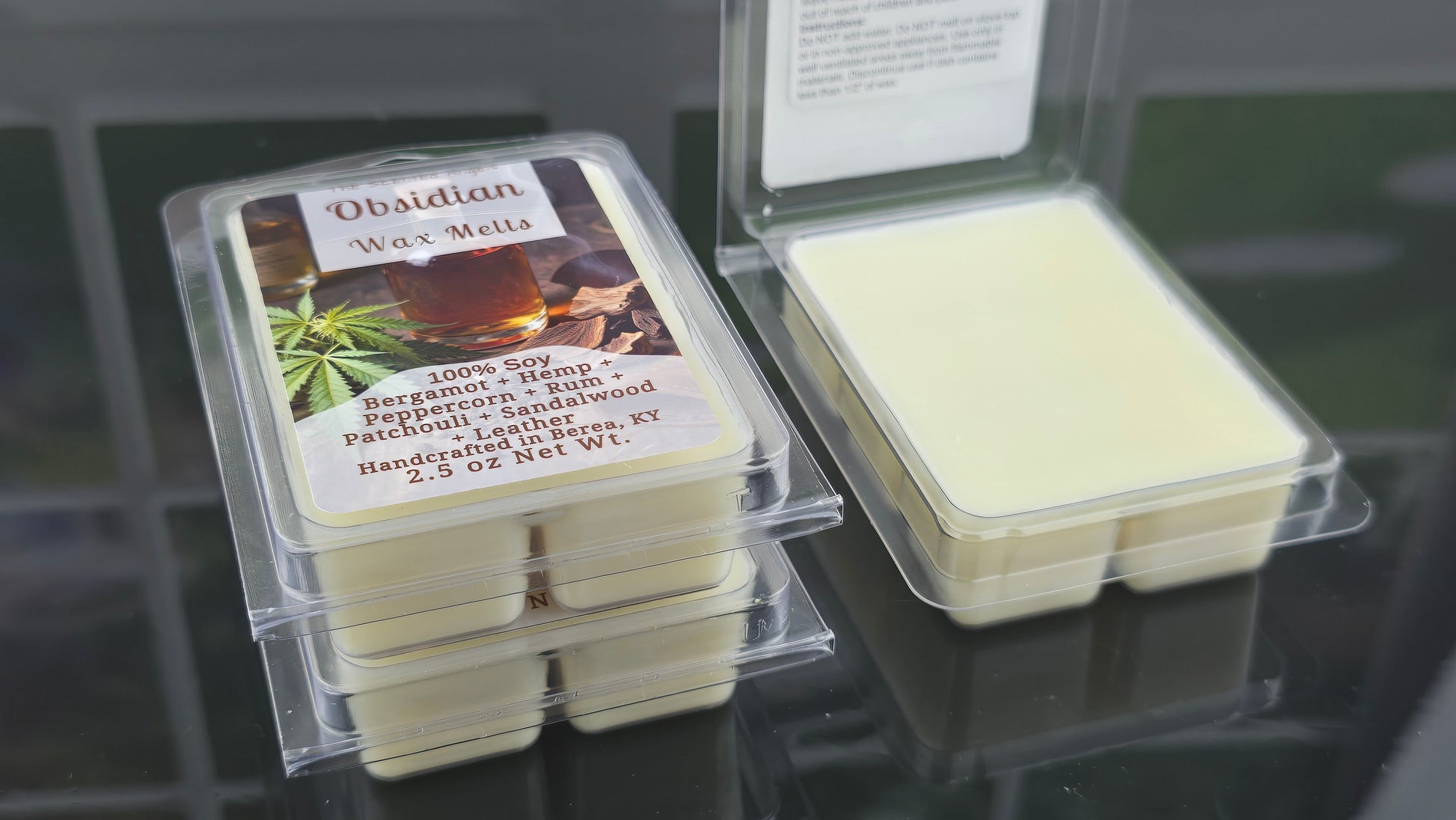 Packaged wax melts with a visible label on a reflective surface