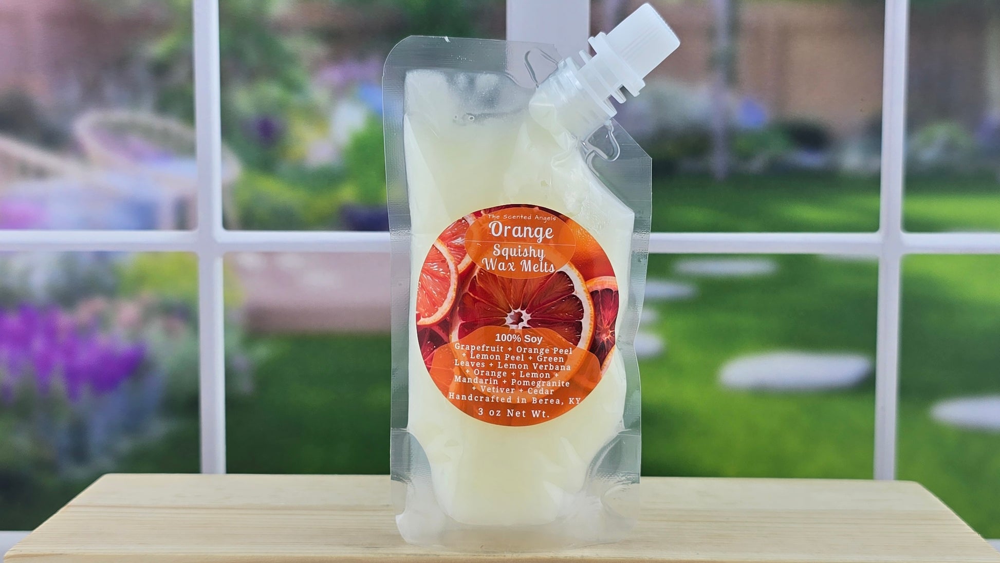 Squeezable wax melt pouch on wooden surface with blurred background